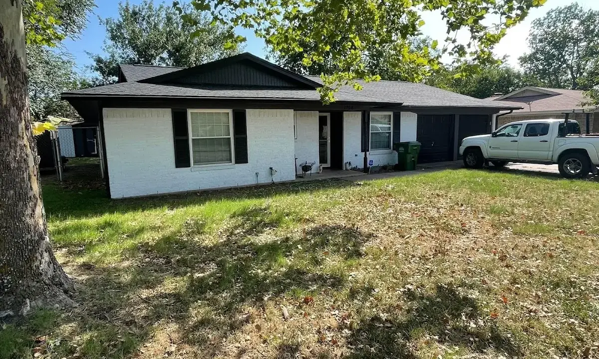 Professional roofing crew working on a residential roof in Naples Manor